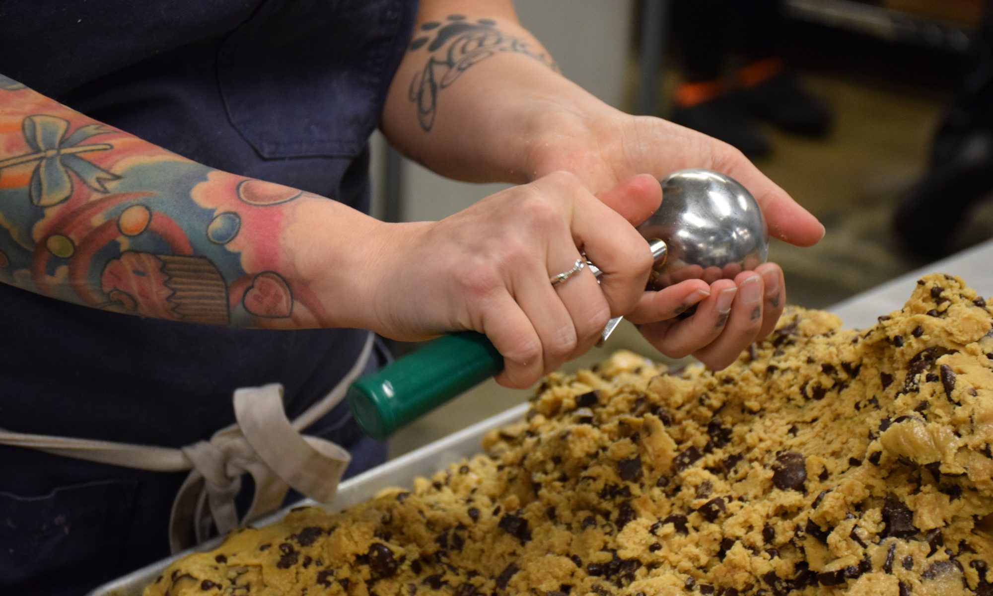 Executive Pastry Chef Lori Sauer scoops cookie dough at Crafted Baked Goods in Liberty Station.